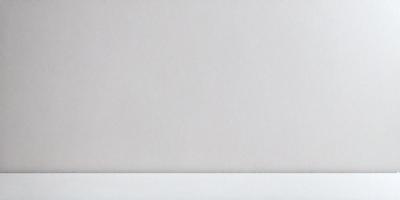 The primary subject of the image is a white wall. The setting is a plain, empty room with no other objects or people visible. The visual style is a simple, clean, and minimalist design. The colors and mood are predominantly white, creating a calm and serene atmosphere.