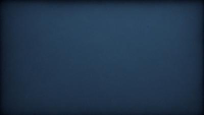 The primary subject of the image is a dark blue sky. The setting is a vast, open space with no visible landmarks or objects. The visual style is a natural, outdoor scene. The colors and mood are predominantly dark and moody, with the blue sky serving as the main focal point.