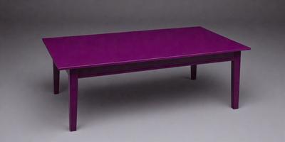 The primary subject of the image is a purple table. The table is placed on a grey surface, which serves as the setting or background. The visual style of the image is a photo, capturing the purple table in its natural environment. The dominant colors in the image are purple and grey, creating a calm and sophisticated atmosphere.