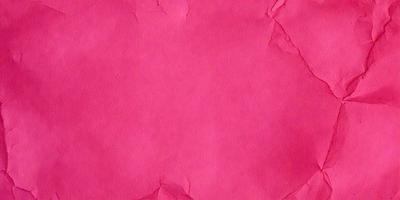 The primary subject of the image is a pink background with a red paper texture. The setting is a close-up of the paper, showcasing its texture and color. The visual style is a close-up of the paper, which gives it a textured and detailed appearance. The colors and mood of the image are predominantly pink and red, creating a warm and inviting atmosphere.