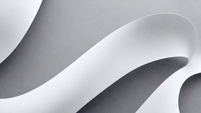 The primary subject of the image is a white paper, which is the main object, scene, or focus of the image. The setting is a gray background, which provides a contrasting and neutral environment for the paper. The visual style of the image is a photo, capturing the paper in its natural form. The colors and mood of the image are predominantly white, giving it a clean and minimalist appearance.