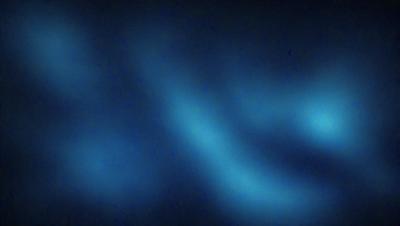 The primary subject of the image is a blue, swirling, and curved pattern. The setting is a dark blue background, which creates a contrasting and visually striking effect. The visual style appears to be a digital art or illustration, as the pattern is intricate and detailed. The colors and mood of the image are predominantly dark and moody, with the blue hues adding a sense of depth and mystery to the scene.