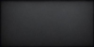 The primary subject of the image is a black background. The setting is a dark room, and the visual style is a black and white photo. The colors and mood are dark and moody, creating a dramatic atmosphere.