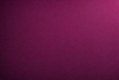 The primary subject of the image is a large, purple wall. The setting is a room with a pink background. The visual style is a close-up of the wall, which gives a sense of depth and texture. The dominant colors are purple and pink, creating a warm and inviting atmosphere.