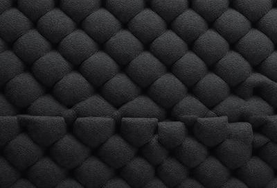 The primary subject of the image is a black and white patterned wall. The setting is a black background, and the visual style is a patterned texture. The dominant colors are black and white, creating a bold and striking appearance.