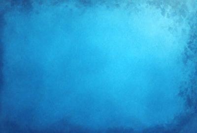 The primary subject of the image is a large, blue, cloudy sky. The setting is a vast, open space with no visible landmarks or objects. The visual style is a digital art or illustration, as the sky appears to be a painting or drawing. The colors and mood of the image are predominantly blue, creating a serene and peaceful atmosphere.