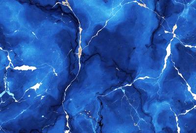 The primary subject of the image is a blue marble wall with a pattern of white streaks. The setting is a room with a blue marble floor. The visual style is a close-up of the marble wall, showcasing its unique texture and design. The colors and mood of the image are predominantly blue, creating a calm and serene atmosphere.