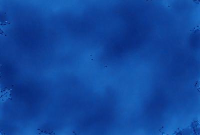 The primary subject of the image is a blue sky filled with clouds. The setting is a clear day with no visible landmarks or objects. The visual style is a natural, outdoor scene. The colors and mood are predominantly blue, creating a calm and serene atmosphere.