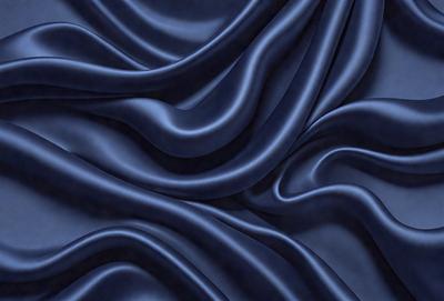 The primary subject of the image is a blue fabric, which appears to be a piece of cloth or a curtain. The setting is a dark background, which contrasts with the blue fabric. The visual style is a close-up of the blue fabric, showcasing its texture and details. The colors and mood of the image are predominantly blue, creating a calm and serene atmosphere.