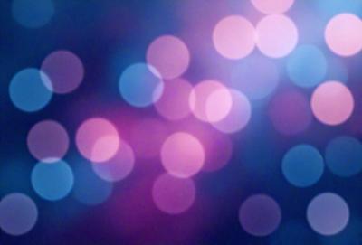 The primary subject of the image is a brightly colored, swirling pattern of lights. The setting is a dark blue background, which contrasts with the vibrant colors of the lights. The visual style is a mix of digital art and illustration, creating a dynamic and eye-catching pattern. The colors and mood of the image are energetic and lively, with the bright lights and dark blue background creating a sense of depth and contrast.