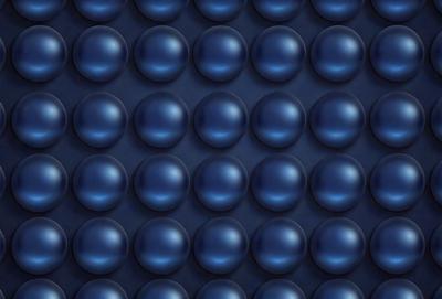 The primary subject of the image is a blue wall with a pattern of blue circles. The setting is a room with a blue background, and the visual style is a close-up of the blue wall. The dominant colors and overall atmosphere are blue and calm.