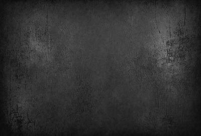 The primary subject of the image is a gray wall with a rough texture. The setting is a room with a gray background. The visual style is a photo of a gray wall. The dominant colors are gray, and the overall atmosphere is calm and uncluttered.