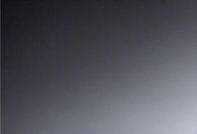 The primary subject of the image is a dark, cloudy sky. The setting is a vast, open space with no visible landmarks or objects. The visual style is a black and white photo, which adds a sense of depth and contrast to the scene. The colors and mood of the image are predominantly dark and moody, with the clouds and sky creating a dramatic atmosphere.