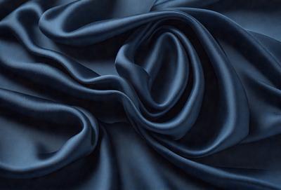 The primary subject of the image is a blue fabric, which is the main object, scene, or focus of the image. The setting or background is a blue cloth, and the visual style is a photo. The dominant colors and overall atmosphere are blue and dark, creating a moody and dramatic effect.