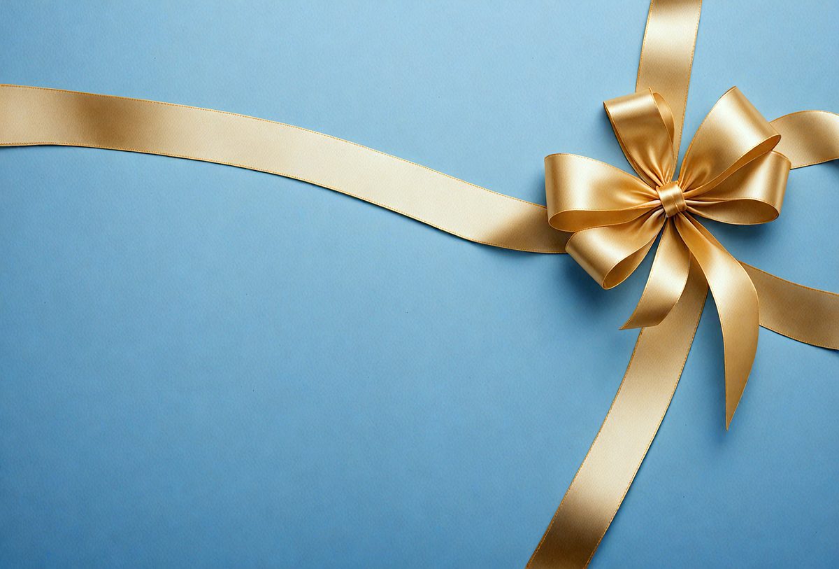 The primary subject of the image is a gold ribbon bow, which is placed on a blue background. The ribbon bow is the main focus of the image, and it appears to be a realistic representation of a ribbon bow. The setting is a blue surface, which provides a contrasting background for the gold ribbon bow. The visual style of the image is realistic, and the colors and mood convey a sense of elegance and sophistication.