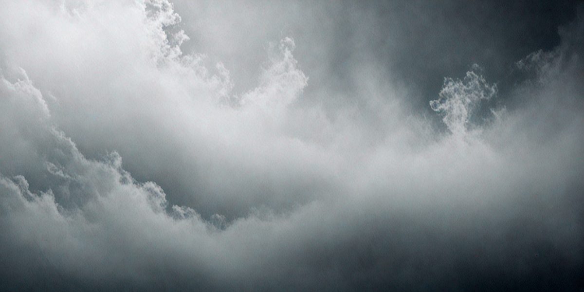 The primary subject of the image is a cloudy sky. The setting is a dark, cloudy day with a gloomy atmosphere. The visual style is a photo, capturing the cloudy sky in its natural environment. The colors and mood are predominantly dark and moody, with the clouds creating a dramatic backdrop.