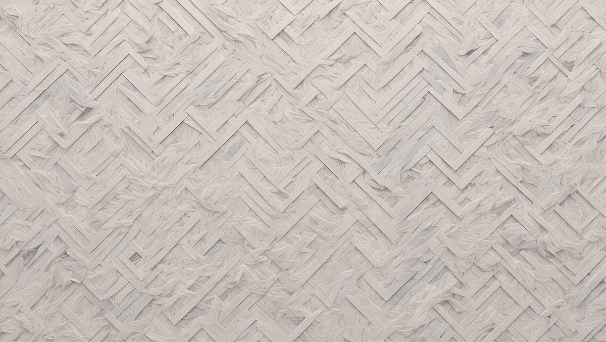 The primary subject of the image is a large, intricate, and textured wallpaper design. The wallpaper features a pattern of interlocking diamond shapes, creating a visually appealing and unique design. The setting is a room with a white background, which highlights the wallpaper's texture and pattern. The visual style of the image is a close-up of the wallpaper, showcasing its details and craftsmanship. The colors and mood of the image are predominantly white, giving it a clean and elegant appearance.