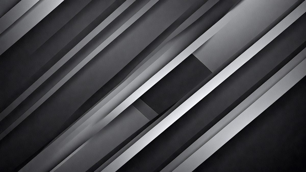 The primary subject of the image is a black and white photo of a silver metal surface. The setting is a dark room, and the visual style is a close-up of the metal surface. The colors and mood of the image are predominantly black and white, creating a sense of depth and contrast.