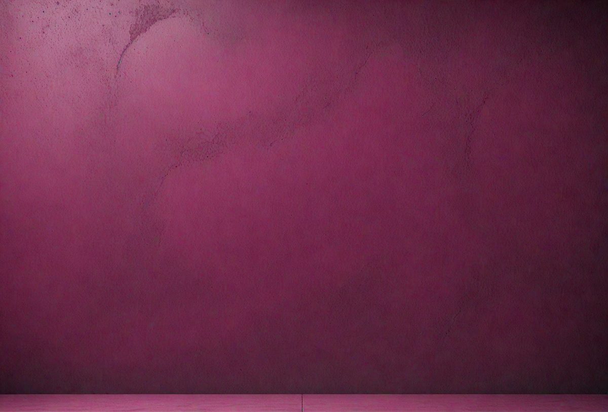 The primary subject of the image is a wall with a purple color. The setting is a room with a pink floor, and the visual style appears to be a photo. The dominant colors are purple and pink, creating a warm and inviting atmosphere.