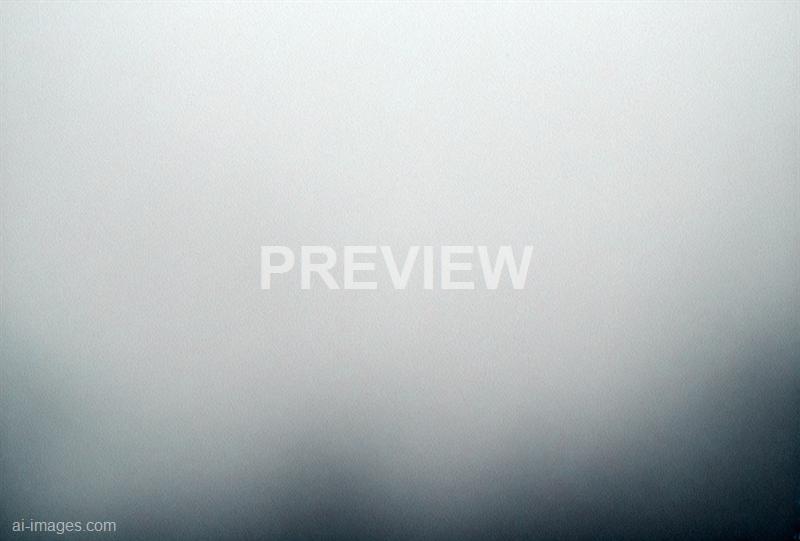 The image appears to be mostly blank or out of focus, with a gradient of light to darker tones from top to bottom, possibly indicating a close-up of a textured surface or a blurred background. There are no distinct objects, people, or scenery visible in the image.